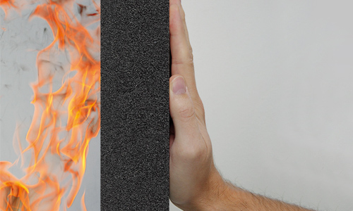 hand against foamglas with fire