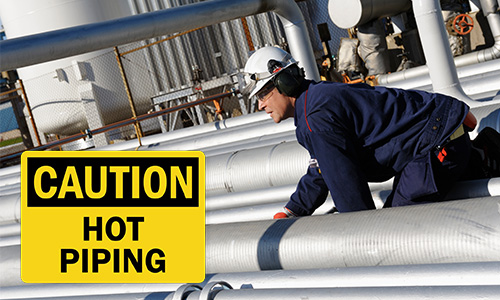 Hot service pipes with caution sign