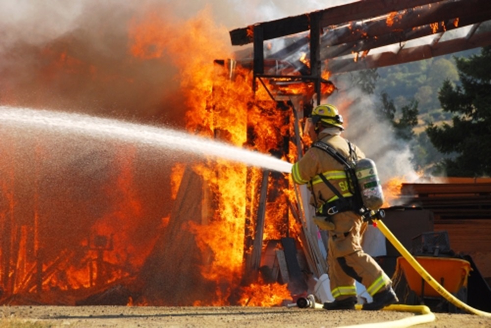 Firefighter extinguishing a industrial fire
