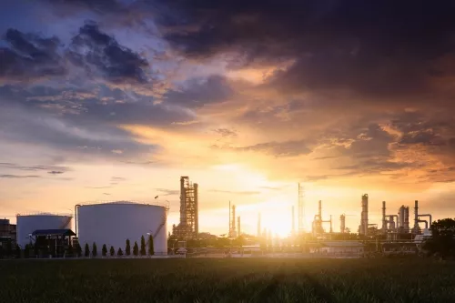 Oil tank and columns during sunset at petrochemical plant