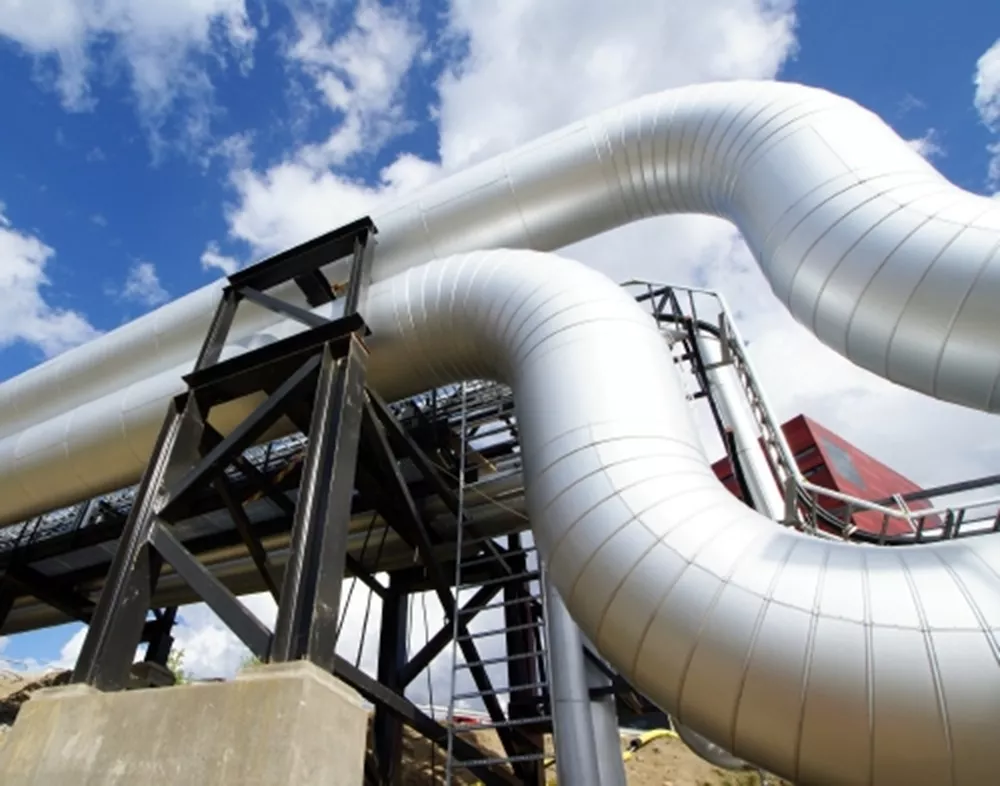 Piping with cladding at oil and gas processing plant