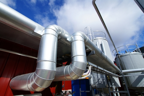 Piping with cladding at oil and gas processing plant