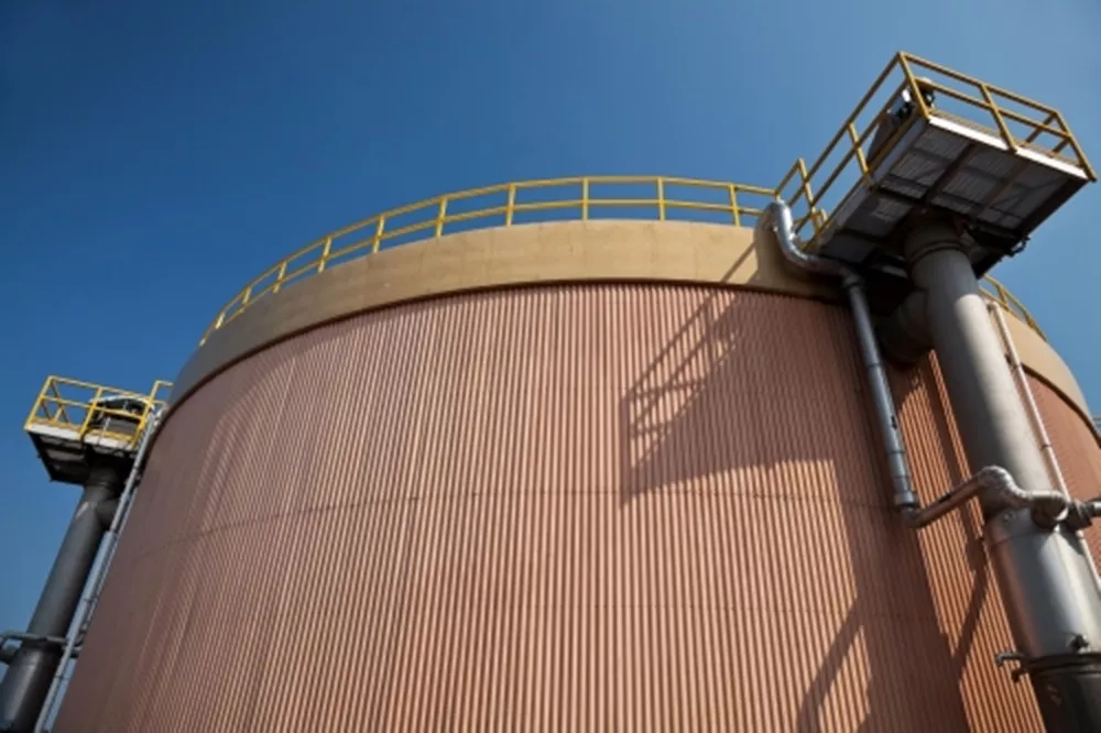 Storage tank with blue sky at processing facility